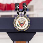 Church Massacre Ignites Trump Fury – See His Reaction! Vice Presidential podium with microphones and emblem.