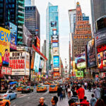 World Leader HUMILIATED—NYC Police Freeze Macron Times Square crowded with people and bright electronic advertisements.