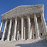 Justice Thomas Drops Bombshell—Core Rights at Risk! The Supreme Court building featuring grand columns and statues under a clear blue sky