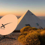 Starlink DISASTER—Thousands at Risk, Zero Warning Given Satellite dish near pyramid-shaped building at sunset.