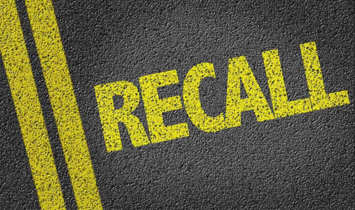 Yellow RECALL text on asphalt background.