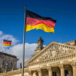 BOMB THREAT Shuts Down Oktoberfest – MUNICH REELING! German flags at the Reichstag building in Berlin.