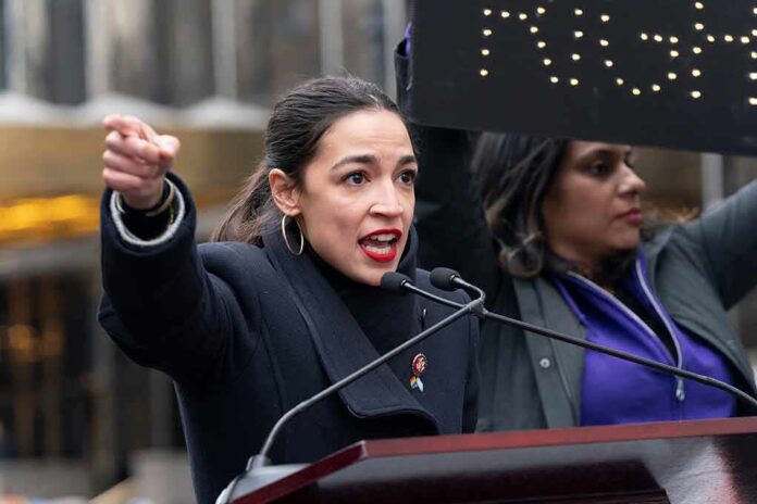A woman passionately speaking at a rally with a sign in the background