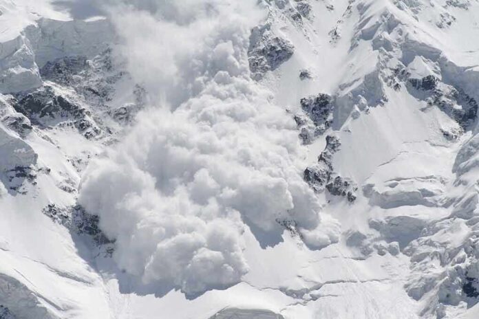 shutterstock_17964235.jpg An avalanche occurring on a snowy mountain slope