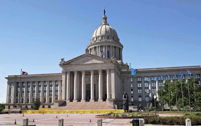 Exterior view of a state capitol building with a dome and flags