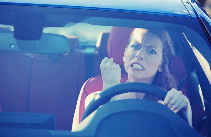 shutterstock_223380148.jpg Angry woman gripping the steering wheel in a car
