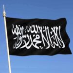 TRUMP THREATENS Hamas – Take Deal or Hell To Pay! Black flag featuring Arabic script against a blue sky