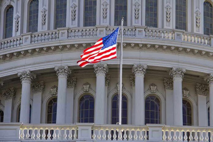 American flag waving in front of the Capitol building