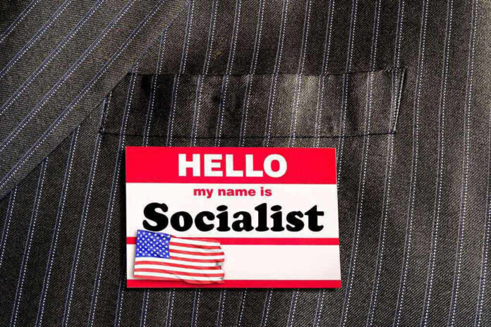 1306450240 Hello my name is Socialist name tag on suit.