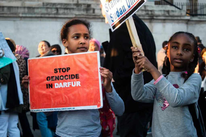 Children holding signs at a protest against Darfur genocide.