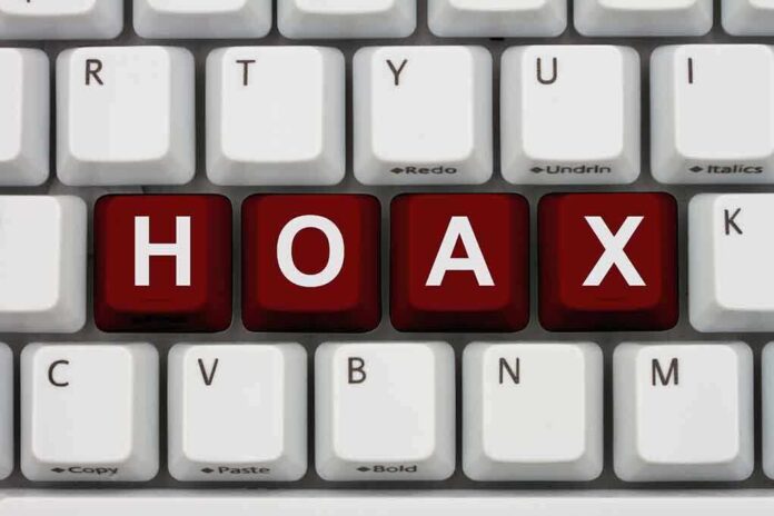 Close-up of a computer keyboard with the word HOAX spelled out in red keys
