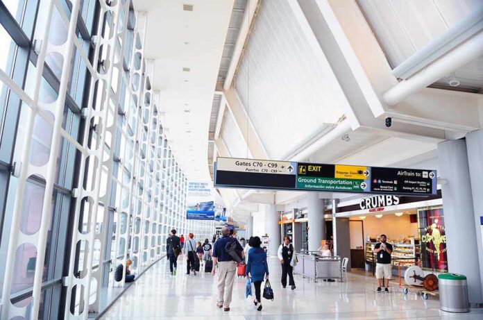 Interior of an airport terminal with travelers and signage