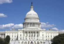 U.S. Capitol building against blue sky.