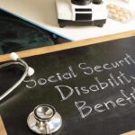 Stethoscope and chalkboard saying Social Security Disability Benefits.