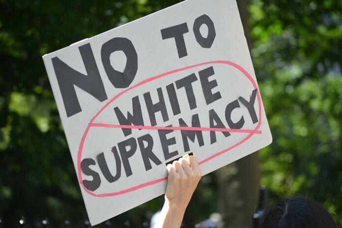 Sign saying No to white supremacy with red circle.