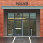 Twerking Cop Sparks Major Police Scandal Entrance of a modern police station with brick facade