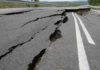 Road damaged by significant cracks and fissures.