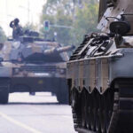 Trump UNLEASHES Heavy Armor — Middle East SHOCKED Tanks on a road with soldiers inside.