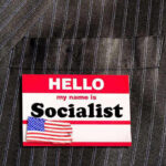 Hello my name is Socialist name tag on suit.