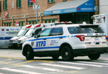 NYPD’s Intense Standoff: 50 Arrested Police car and ambulances outside emergency room entrance.