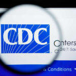 CDC Ditches Universal Vaccines—Health Experts Alarmed CDC logo magnified on a screen.