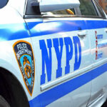 NYPD police car with logo and text.