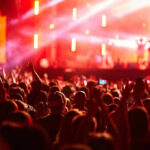 Springsteen CONCERT Becomes a Bizarre SOAPBOX Crowd at concert with vibrant stage lights.