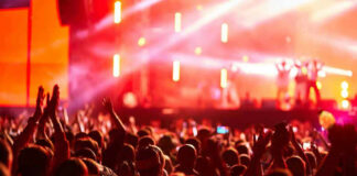 Crowd at concert with vibrant stage lights.
