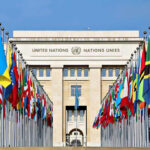 Somali Ambassadors Secret Business Exploits Exposed! United Nations building with numerous national flags outside.