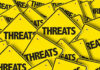 Yellow warning signs with the word THREATS.