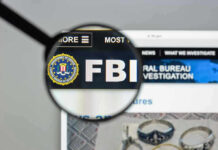 FBI Veteran Chosen to Replace Bongino FBI website shown through magnifying glass.