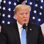 Trump Threatens Countries Opposing His Effort to Control Greenland A man speaking at a podium with American flags in the background