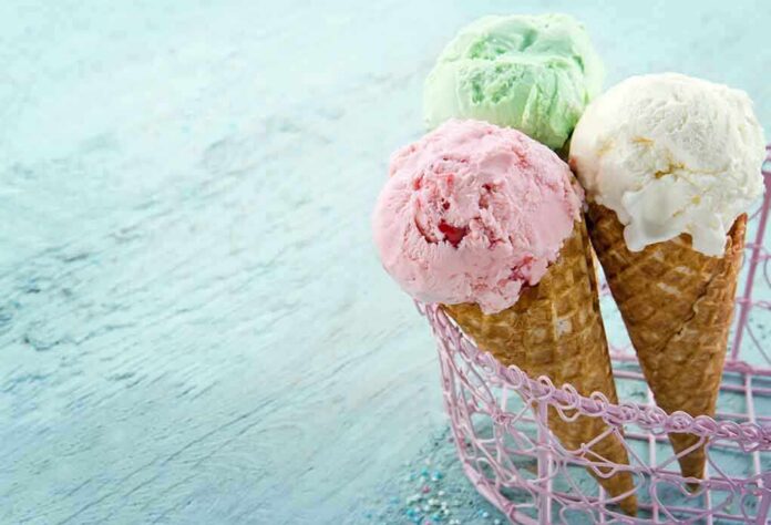 Three ice cream cones with different flavors in a pink basket