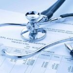 Insurance Giants GRILLED – RELIEF on the WAY A stethoscope resting on a medical billing statement