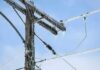 Winter Storm CRIPPLES Power Grid–See WHERE Icy power lines and a utility pole against a blue sky