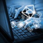 Hands typing on a laptop keyboard with floating email icons