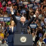Governor Walz QUITS Amid Scandal Storm A political leader gestures enthusiastically at a rally with a supportive crowd