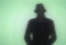 Silhouette behind frosted, textured glass in green light.