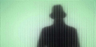 Silhouette behind frosted, textured glass in green light.