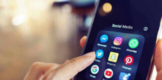 Finger tapping smartphone social media app icons.
