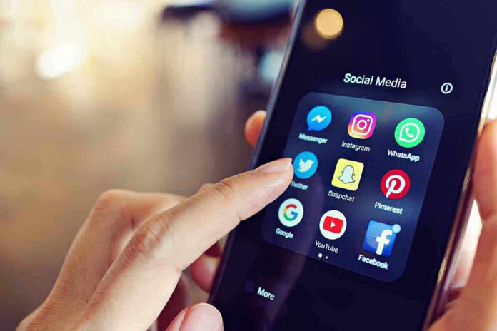 Finger tapping smartphone social media app icons.
