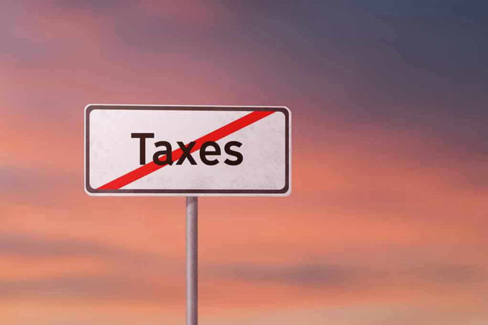 Sign with the word Taxes crossed out.