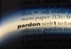 The word pardon highlighted in a dictionary.