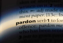 The word pardon highlighted in a dictionary.
