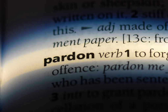The word pardon highlighted in a dictionary.