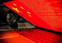 CCP Espionage Ring BUSTED—Olympic Family Attacked Laptop screen displaying Chinese flag and code.