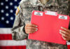 U.S. Army soldier holds a Top Secret folder.