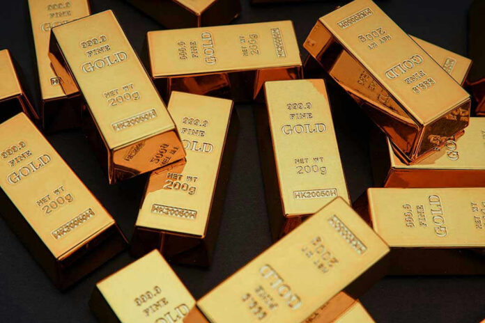 Gold bars stacked on dark background