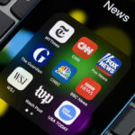 CNN Numbers Torch Schumer’s “Jim Crow” Claim News app icons on a smartphone screen.