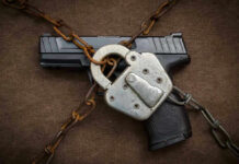 Pistol locked with chains and a padlock.